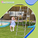 Child on green 4-in-1 kids swing and climbing set in backyard with sofa and ball pit