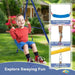 Child playing on blue and yellow kids swing set with adjustable ropes and durable EVA seat outdoors.