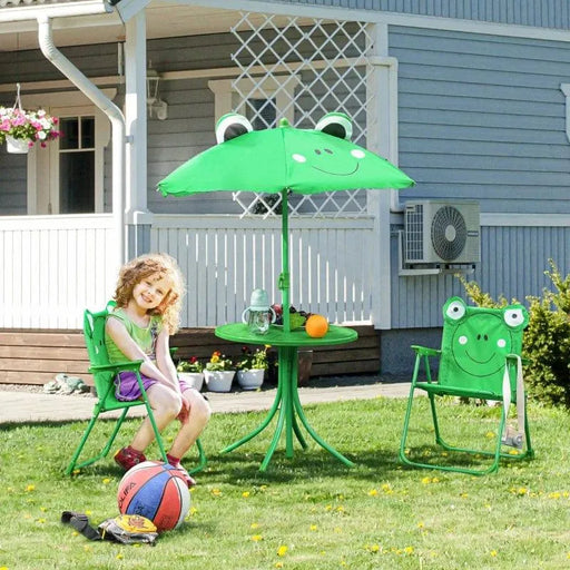 Kids green frog design dining set with chairs, table, and parasol on lawn by a house