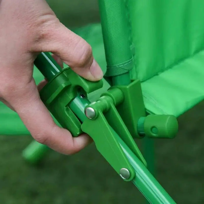 Hand folding green kids dining set chair outdoors, foldable chair mechanism visible