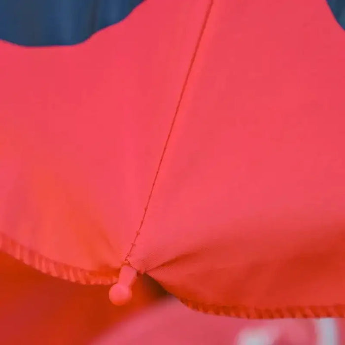Close-up of red parasol fabric with black accent, kids ladybird dining set umbrella