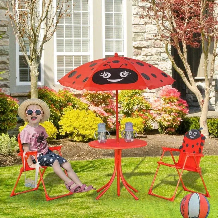 Kids' red and black ladybird dining set with adjustable parasol on lawn, child sitting