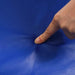 Finger pressing into soft blue foam play mat surface