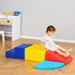 Toddler on colorful 4-piece kids soft play set in modern playroom with wood floor