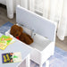 Kids storage bench with U-shaped handle in grey and white, plush bear and books visible