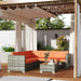 4-piece modular rattan garden sofa set with bright orange cushions and glass coffee table under pergola