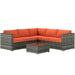 4-piece modular rattan garden sofa set with orange cushions and glass coffee table