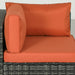 Close-up of 4-piece modular outdoor rattan sofa set with orange cushions and glass table