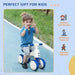 Young child riding white and blue 4-wheel kids balance bike on outdoor path