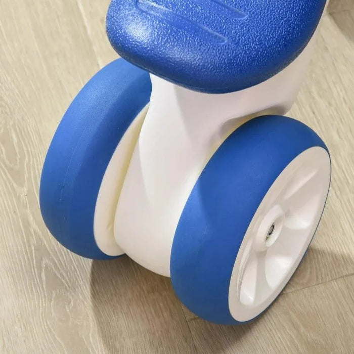 White and blue 4-wheel kids balance bike on light wood floor