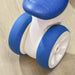 White and blue 4-wheel kids balance bike on light wood floor