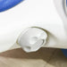 Close-up of white plastic wheel cover on kids' blue and white balance bike on wood floor