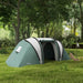 Dark green tunnel tent with two bedrooms and living area set up in a grassy forest clearing