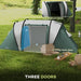 Dark green tunnel tent with two bedroom doors, living room door, and outdoor chairs on grass.
