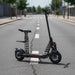 48V folding electric scooter with seat and dual suspension on empty urban street
