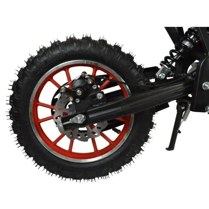 Rear wheel of kids mini dirt bike with red spokes, disc brake, and off-road tire