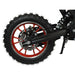 Rear wheel of kids mini dirt bike with red spokes, disc brake, and off-road tire