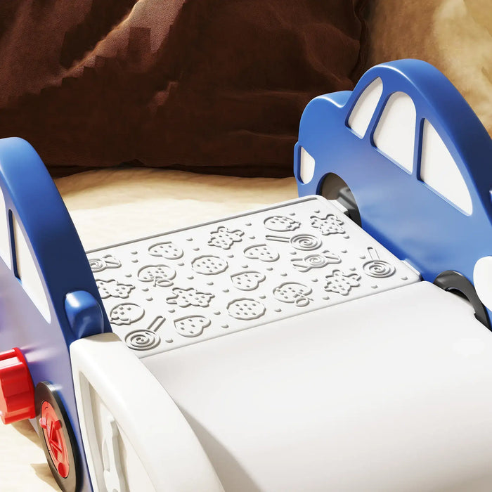 Blue and white children's bed with car-shaped headboards and a textured mattress with fruit patterns