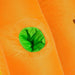 Close-up of orange inflatable bounce house fabric with a green tunnel opening