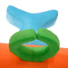 Detail of inflatable bouncy castle with green and blue padded elements on orange base