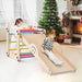Kids on 5-in-1 indoor climbing set with slide, rainbow bars, Christmas tree and fireplace