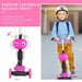 Child riding pink 5-in-1 kick scooter with cartoon face, helmet, and backpack outdoors