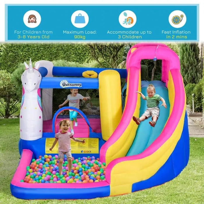 Kids playing on a colorful 5-in-1 unicorn inflatable bouncy castle with slide and ball pit outdoors