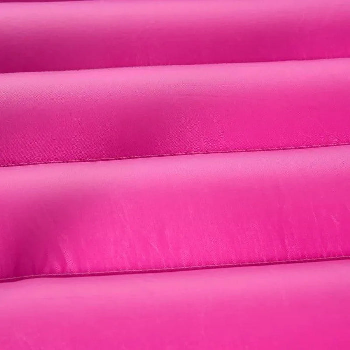 Close-up of pink inflatable bouncy castle steps with textured surface
