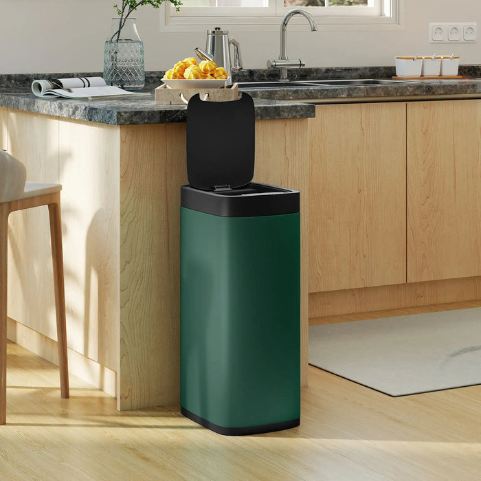 Modern kitchen with green touchless sensor trash bin with open black lid near wooden countertop