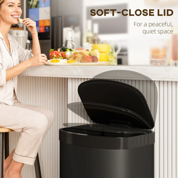 Woman sitting at a kitchen counter with a black trash can featuring a soft-close lid.