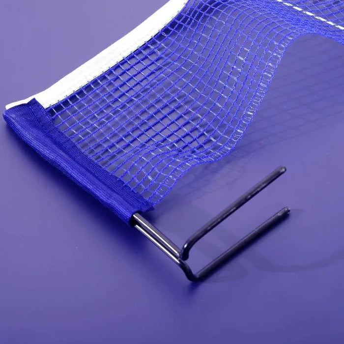 Close-up of blue table tennis net with metal post on purple table surface