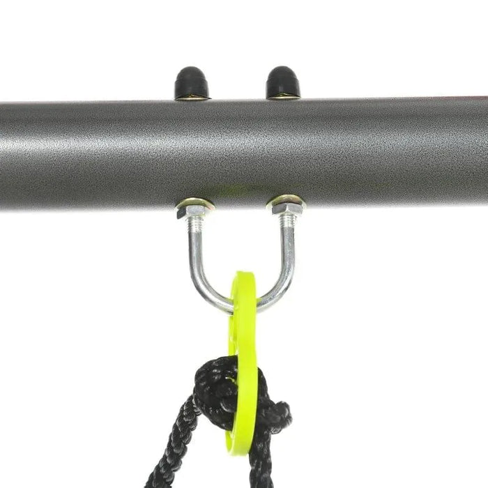 Close-up of swing set metal frame with yellow swing attachment and black rope.