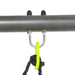 Close-up of swing set metal frame with yellow swing attachment and black rope.