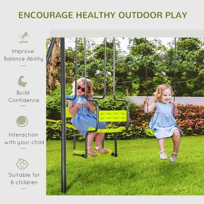 Two young girls playing on a yellow double swing set outdoors on green grass with trees