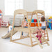 Kids playing on natural wooden indoor jungle gym with slide, rope ladder and monkey bars