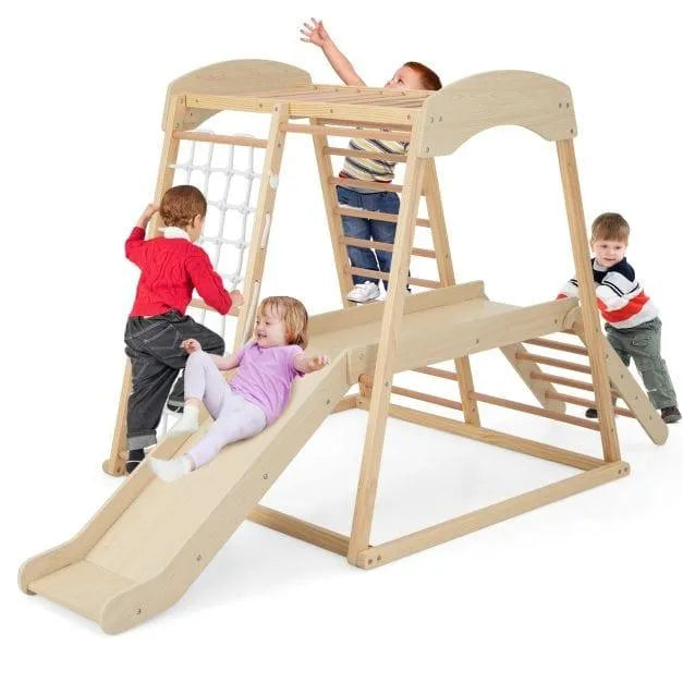 Children playing on a natural wooden indoor jungle gym with slide, monkey bars, and rope ladder
