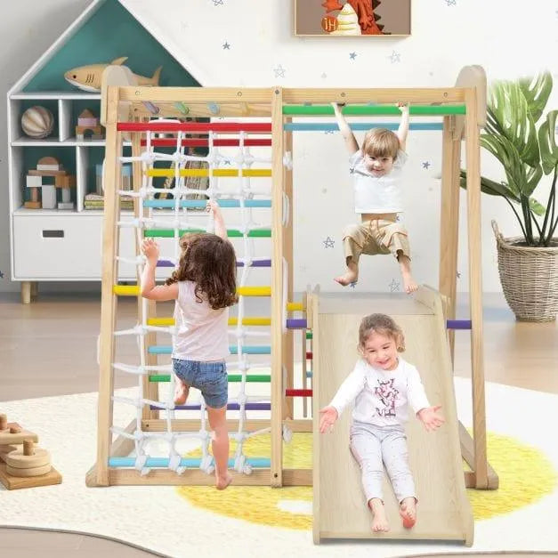 Kids playing on indoor wooden jungle gym with slide, monkey bars, and rope ladder