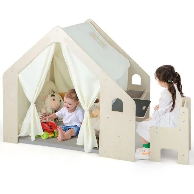 Two children playing in a wooden Montessori indoor play house with curtains and toys.