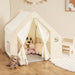 Montessori indoor playhouse with plush toys, child table and chairs in cozy playroom