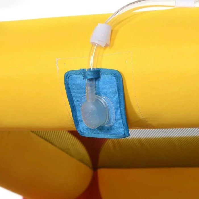 Close-up of inflatable bouncy castle water spray nozzle on yellow and blue material.