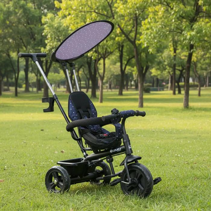 Child's tricycle with sunshade on a grassy area with trees in the background