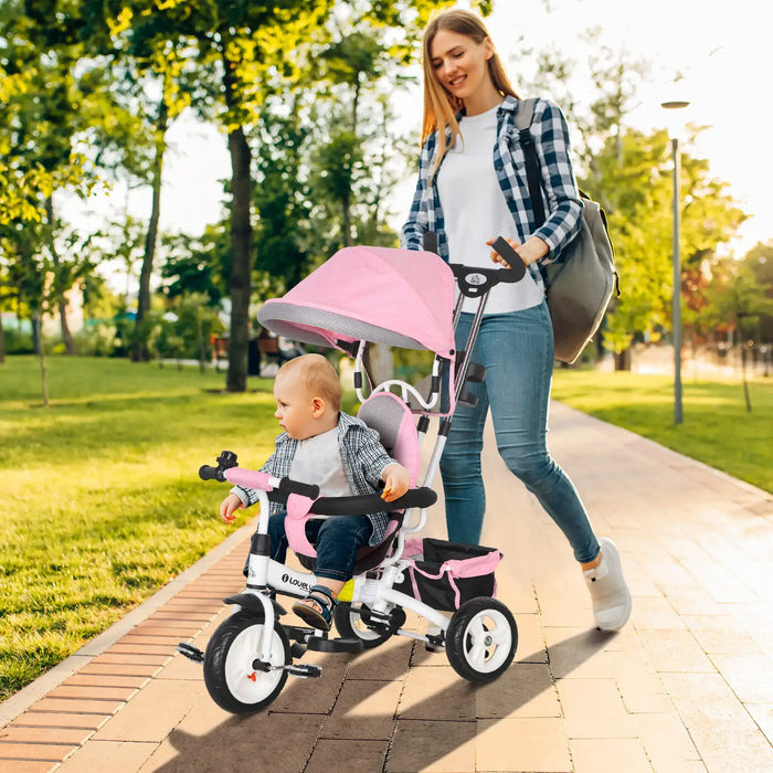 Woman pushing a child in a pink stroller along a path in a park.