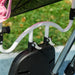 Close-up of a stroller handle with a blurred grass background