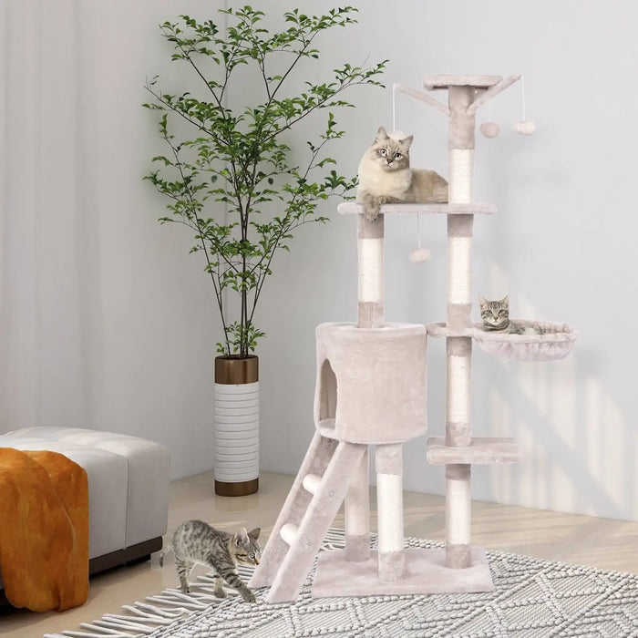 Cat tree with multiple levels and a cat sitting on top in a room with a plant and furniture.