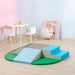 Multi-colour kids soft foam playset with steps in a playroom, beside kids table and chairs