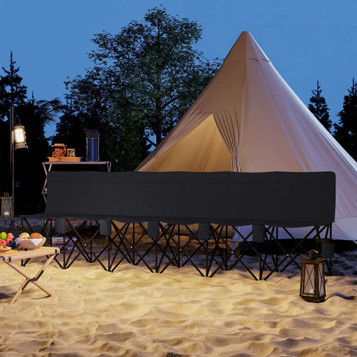 6-seater folding black sports bench with cup holders on sandy campsite at night