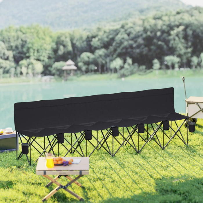 Black 6-seater folding sports bench with cup holders set on grass beside a lake