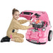 Girl in mechanic outfit playing with pink kids engine toy car workshop set