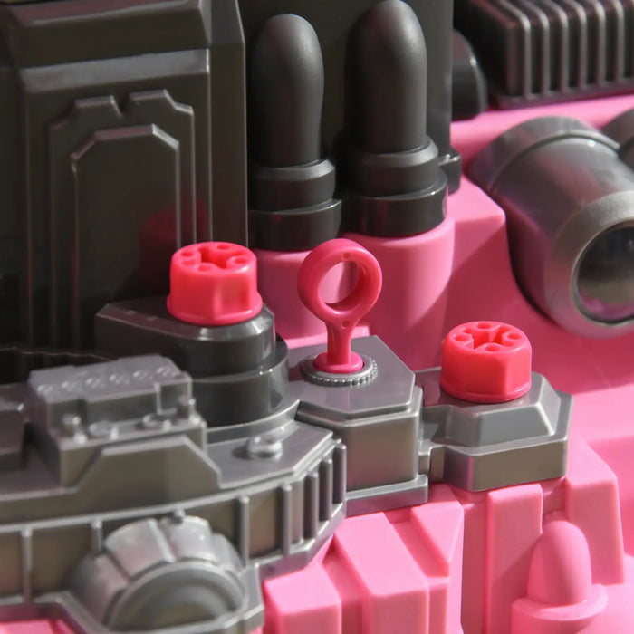Close-up of pink and gray kids toy engine set with workshop vehicle parts