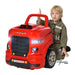 Child in mechanic costume plays with red kids engine toy truck and tool set